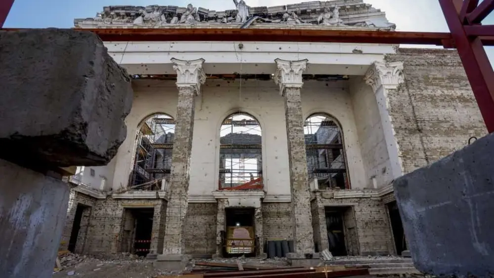 Russia opens rebuilt theater in occupied city years after its airstrikes killed hundreds there