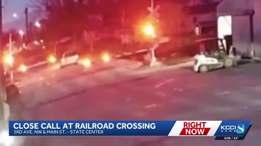 Van drives through active railroad crossing, narrowly misses train