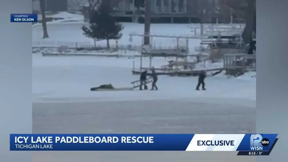 WATCH: Neighbor with a paddleboard helps rescue man who fell in while ice fishing