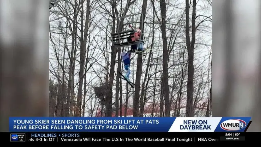 Video captures young skier dangling, falling from ski lift