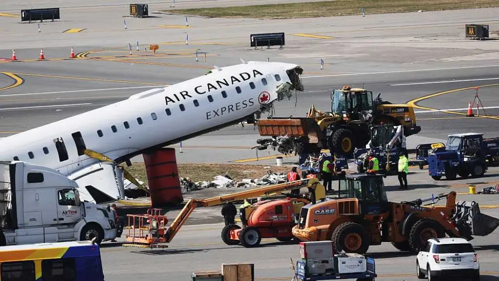 Mangled plane in LaGuardia crash is towed from runway as most injured passengers leave hospital