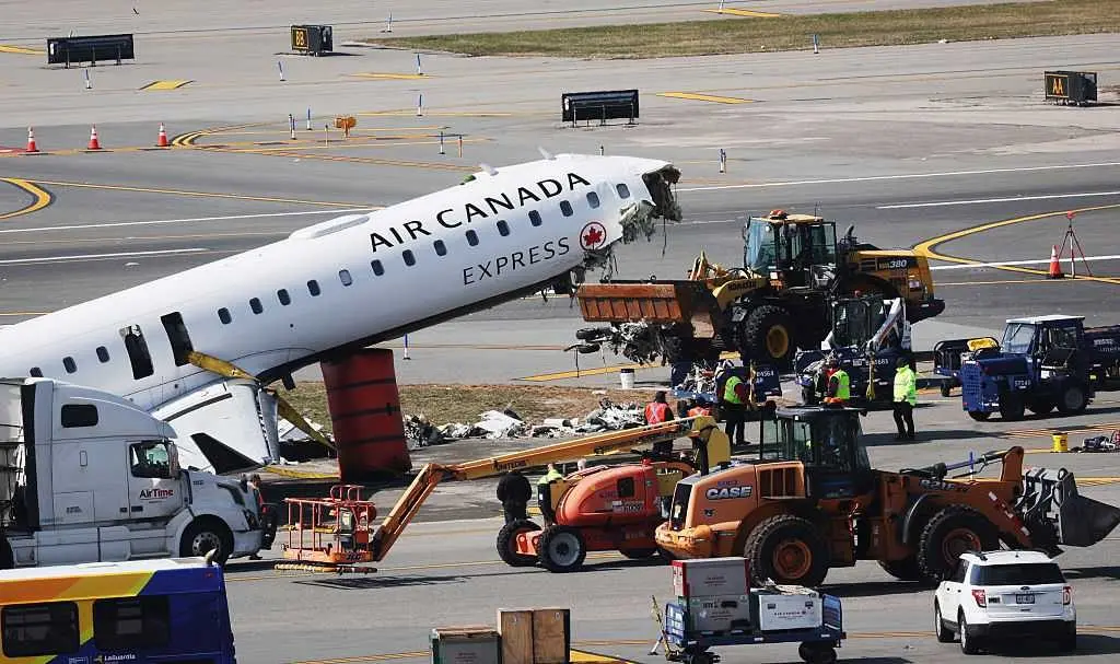 Mangled plane in LaGuardia crash is towed from runway as most injured passengers leave hospital