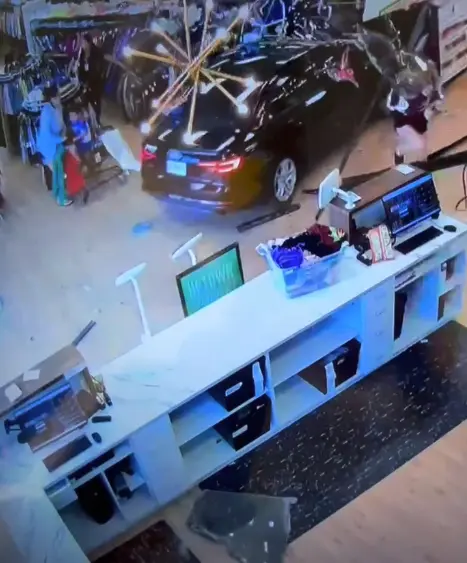 Wild video shows car narrowly missing shopper after ramming through store