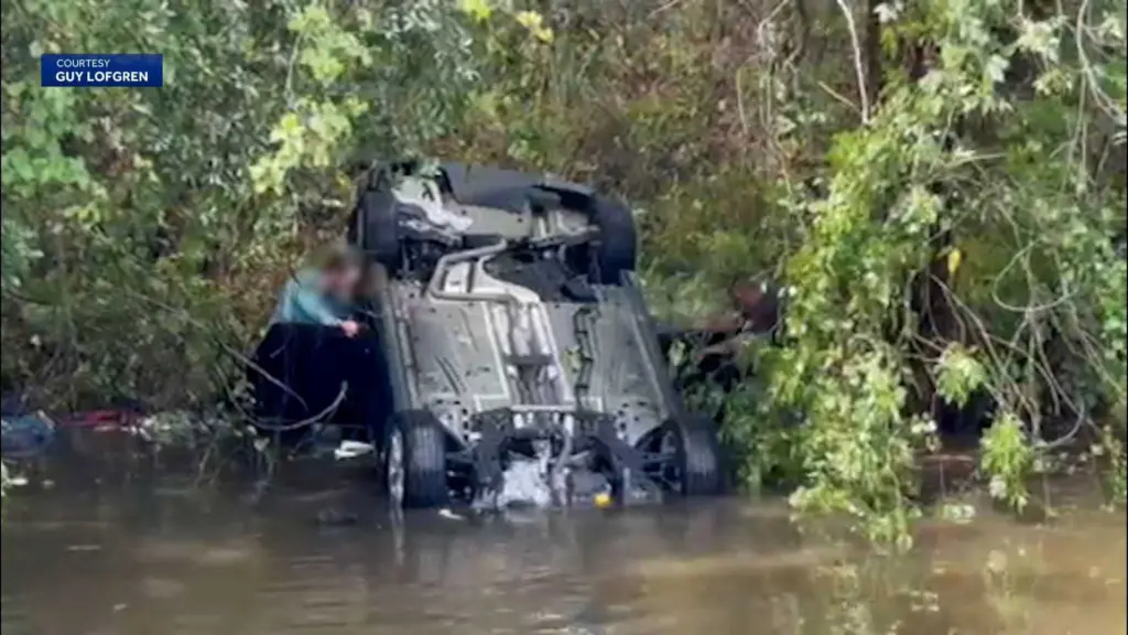 Dramatic video shows car upside down in a creek after crash