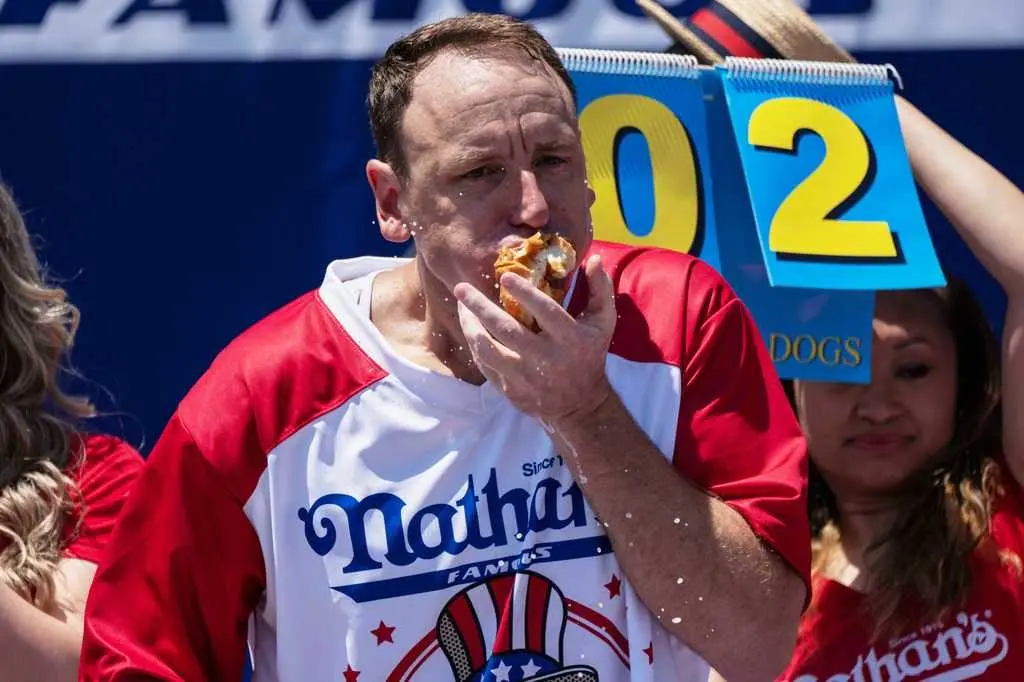Joey Chestnut to defend hot dog eating title while on probation for battery