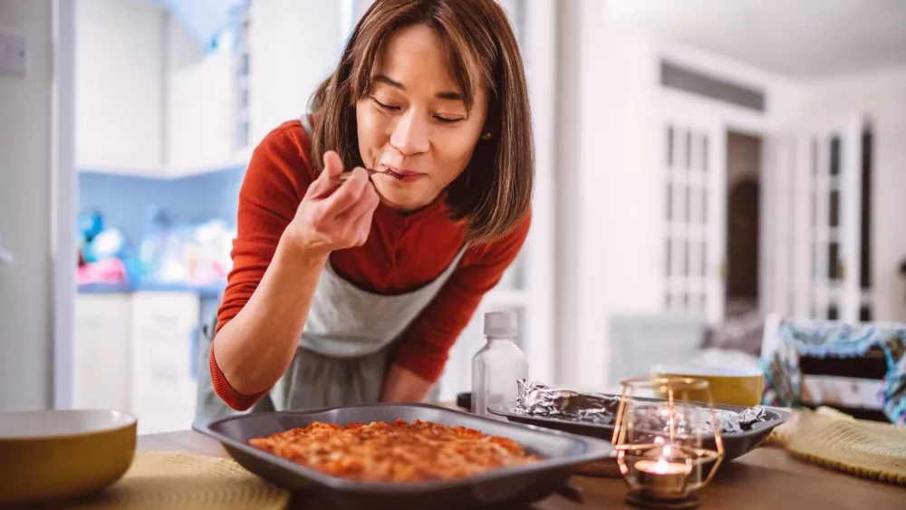 young-pretty-asian-woman-tasting-a-dish-of-pasta-royalty-free-image-1718051746262622