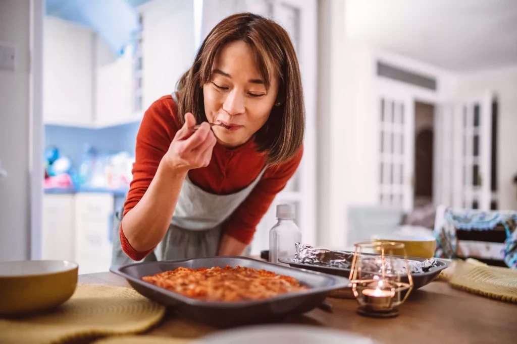 young-pretty-asian-woman-tasting-a-dish-of-pasta-royalty-free-image-1718051746262622