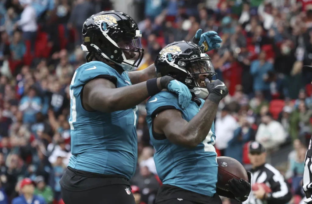 jacksonville-jaguars-running-back-tank-bigsby-right-celebrates-a-1-yard-touchdown-run-against-the-patriots-in-london-671589bbe4f36618650