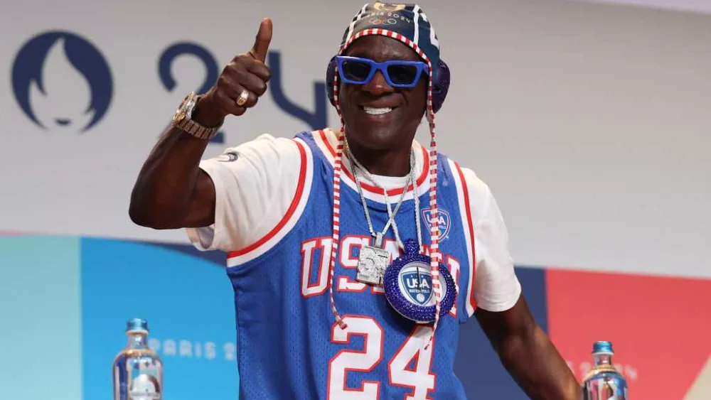 Flavor Flav makes bronze clock necklace for Jordan Chiles