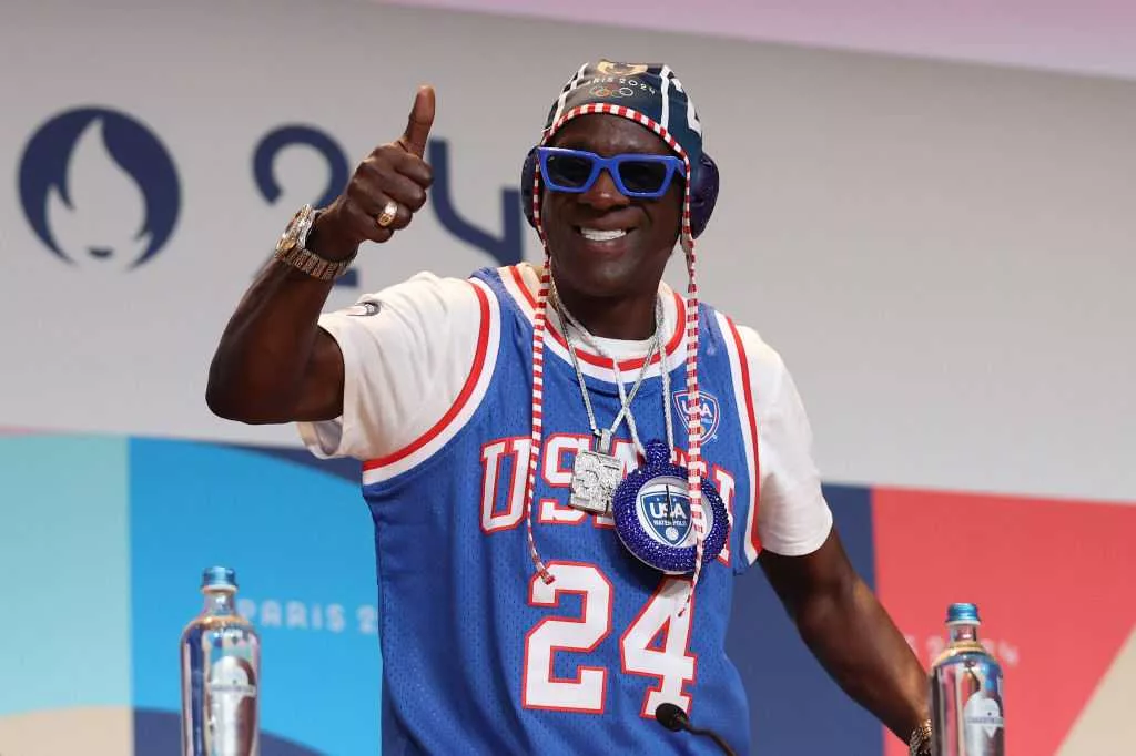 Flavor Flav makes bronze clock necklace for Jordan Chiles