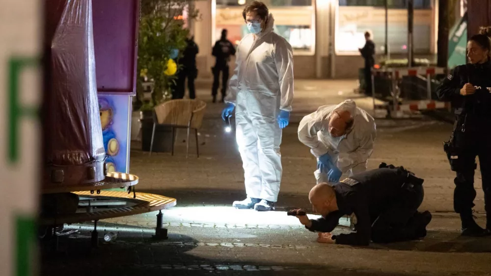 German police scour a western city for a knife attacker who killed 3 at a community festival