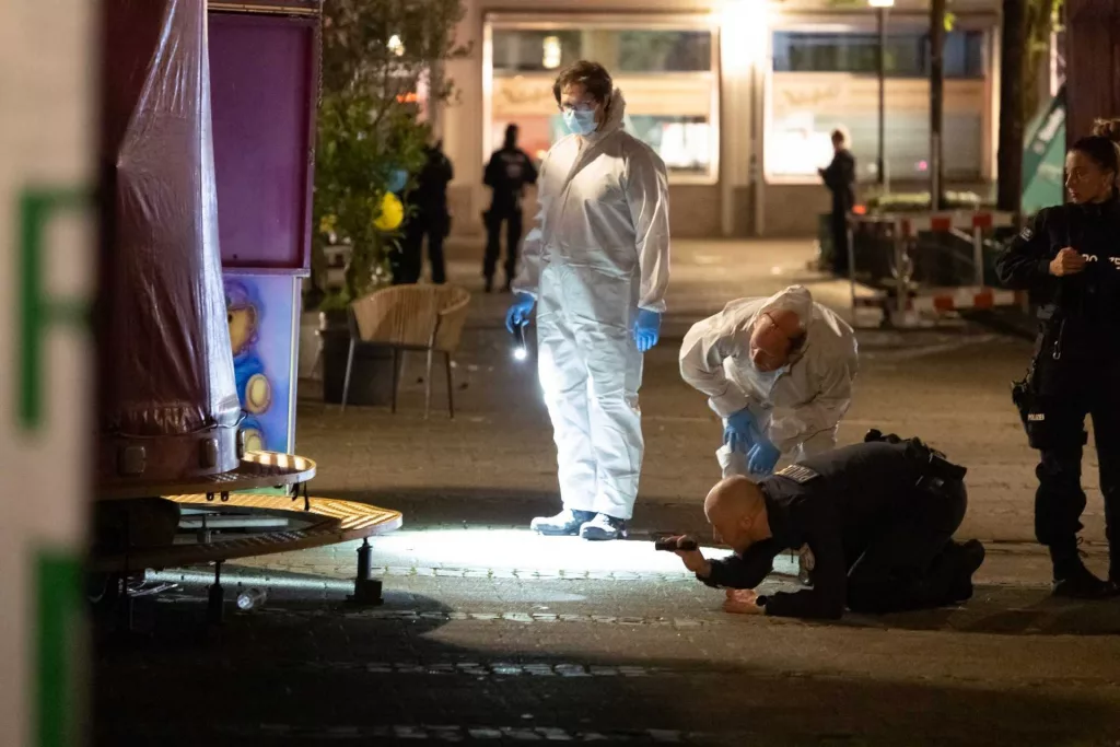 German police scour a western city for a knife attacker who killed 3 at a community festival