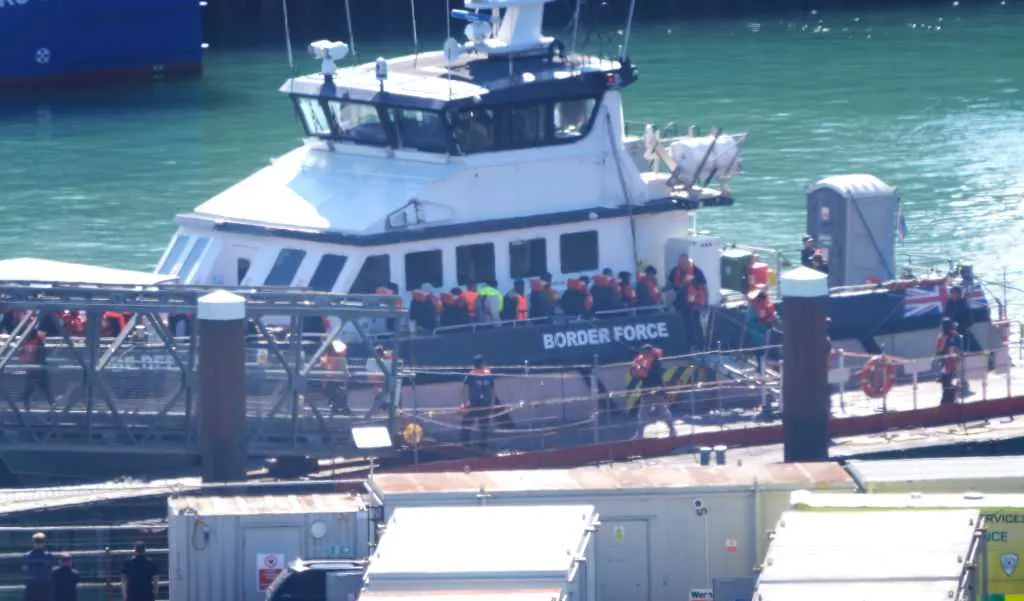 At least 13 are dead after a boat with dozens of migrants rips apart in waters off northern France