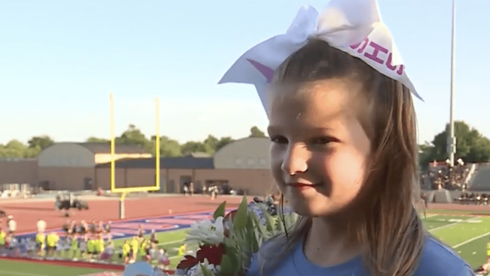 7-year-old girl has dream come true singing national anthem at football game