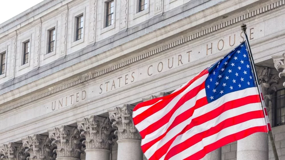 USA national flag waving in the wind in front of United States Court House in New York