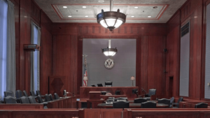 An empty courtroom centered on the judge's bench