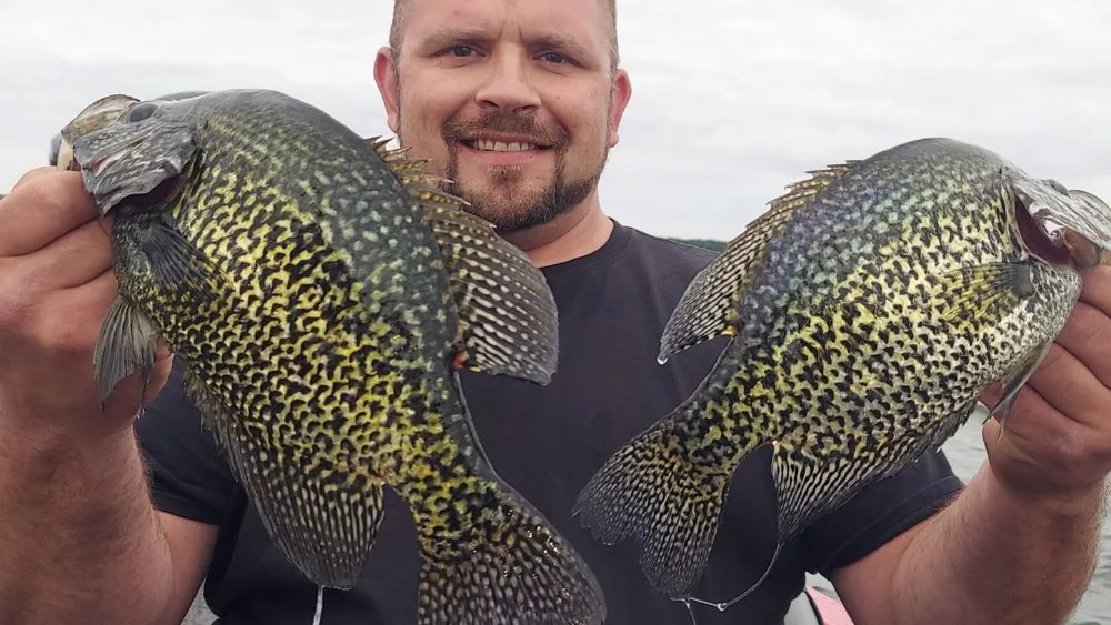 Man holding 2 crappies