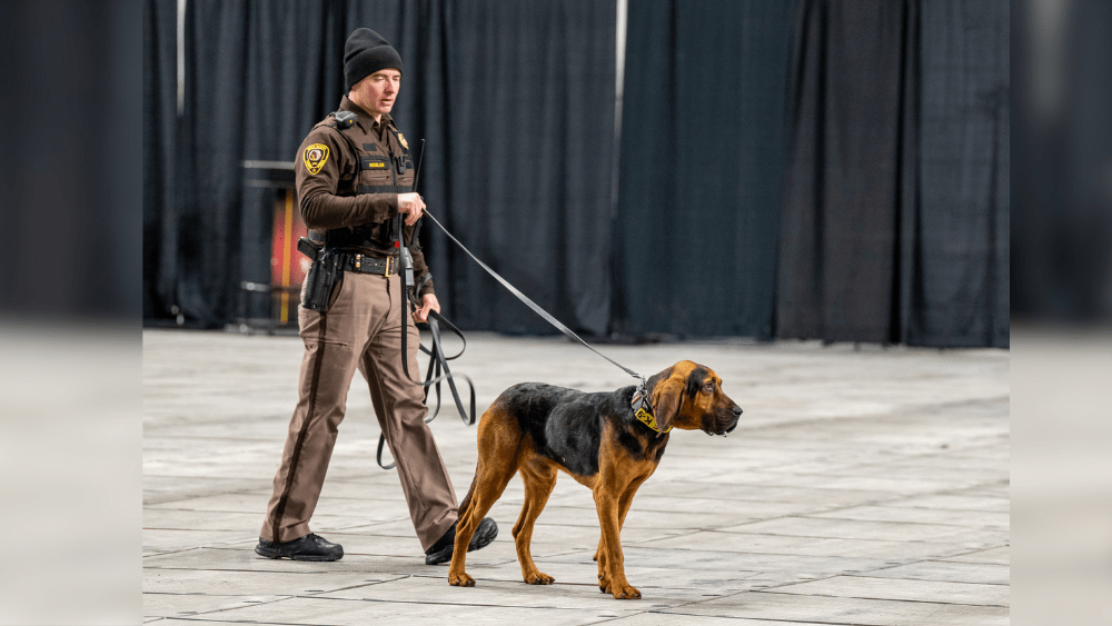 North Dakota Highway Patrol Trooper Nevon Heisler and Judge^ a man trailing K-9
