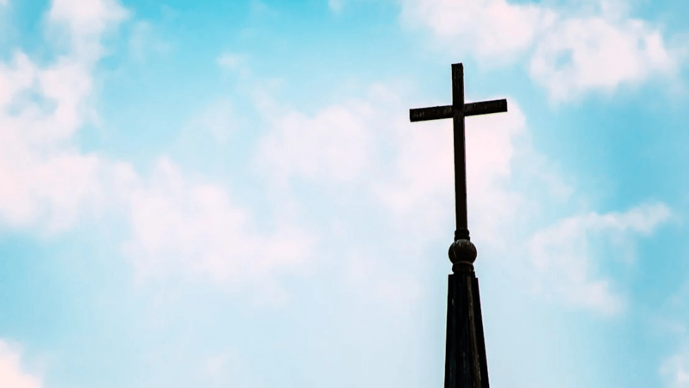 Stock image of a cross on top of a church