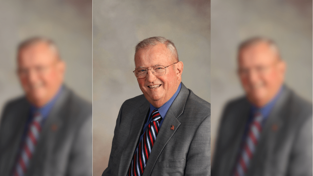 man in front of a tan background