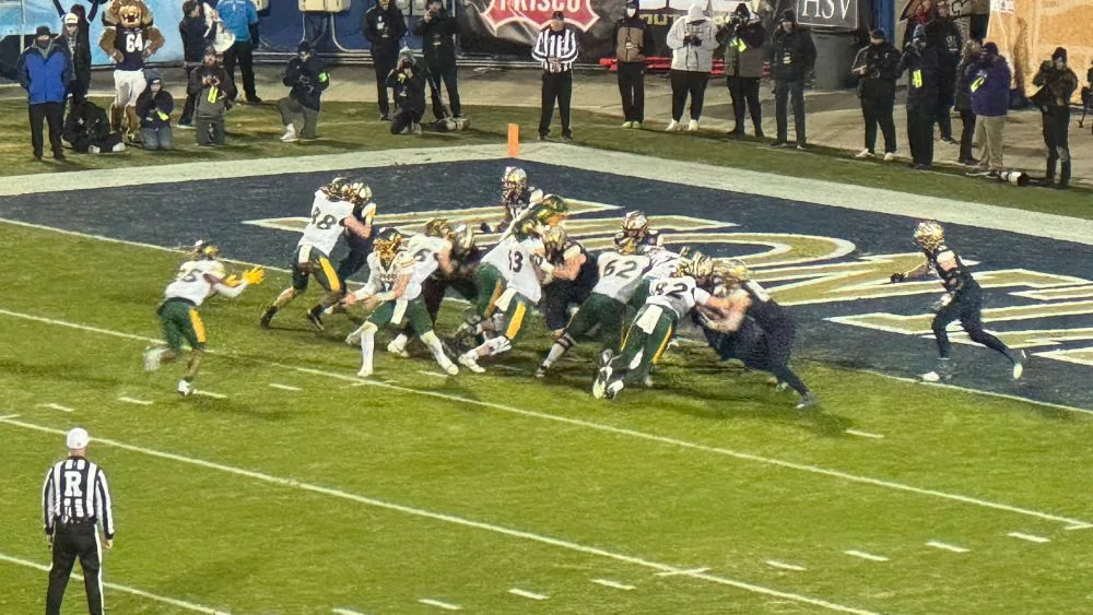 NDSU QB Cam Miller pitching football to Marty Brown