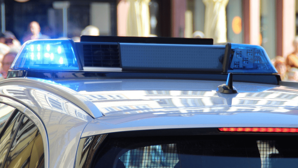 Image of the top of a police car with blue lights