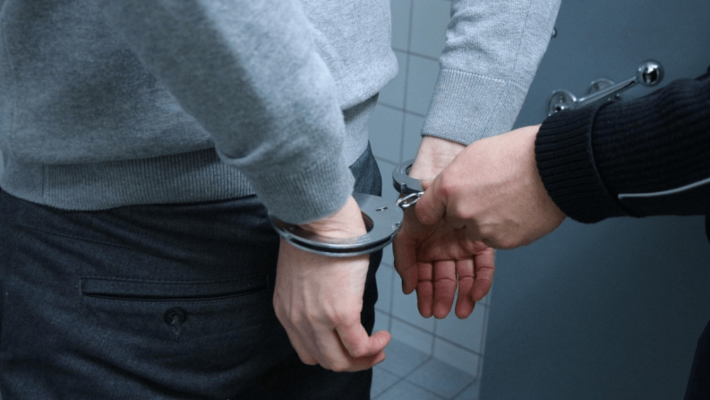 General image of a person handcuffed by police