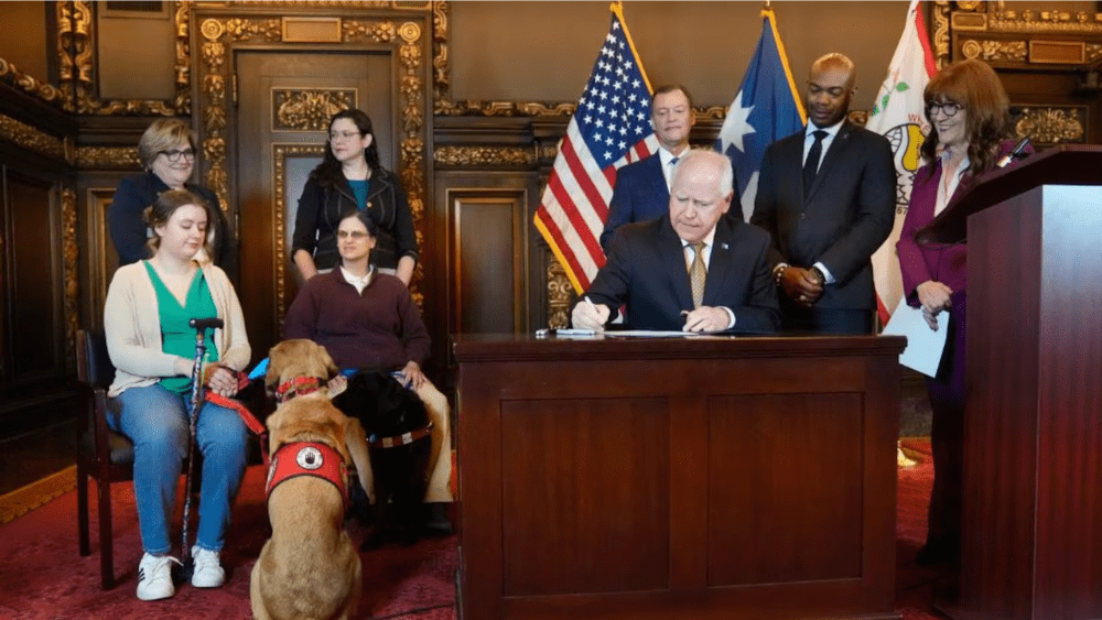 Image of Governor Tim Walz signing legislation