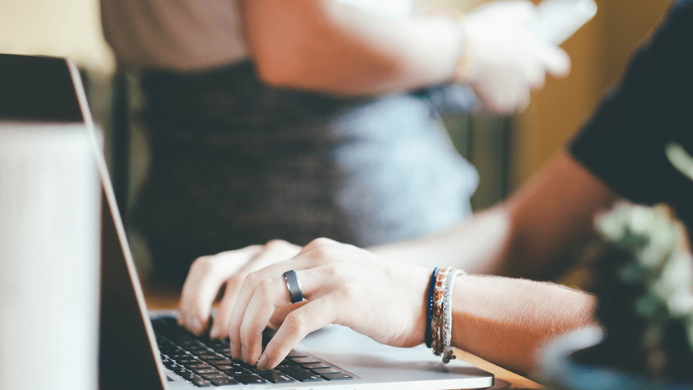 Image of woman typing on a lapto