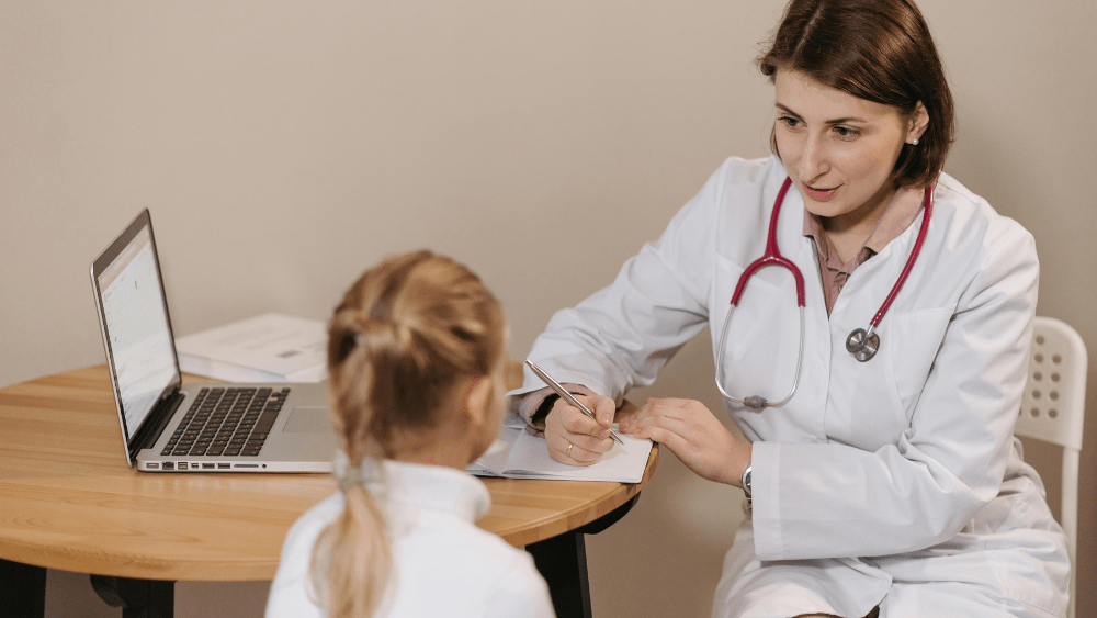 Image of doctor talking to child in office