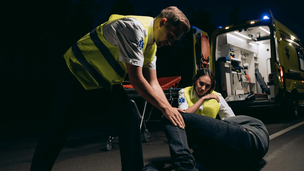 Image of EMTs responding to an injured person on the ground