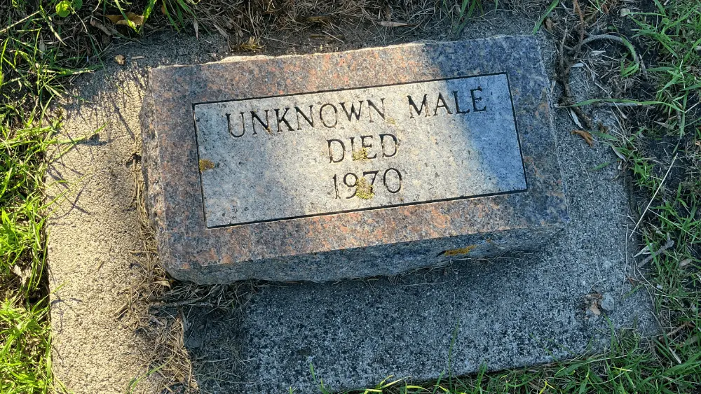 Image of headstone at St. James Cemetery reading "UNKNOWN MALE DIED 1970"