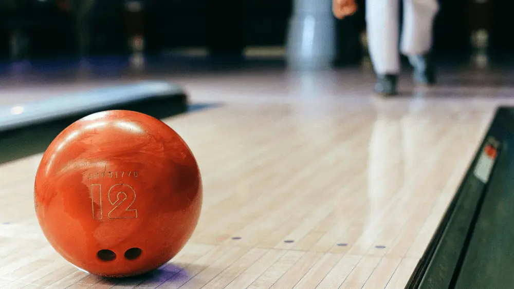 Image of person throwing a bowling ball down a bowling lane