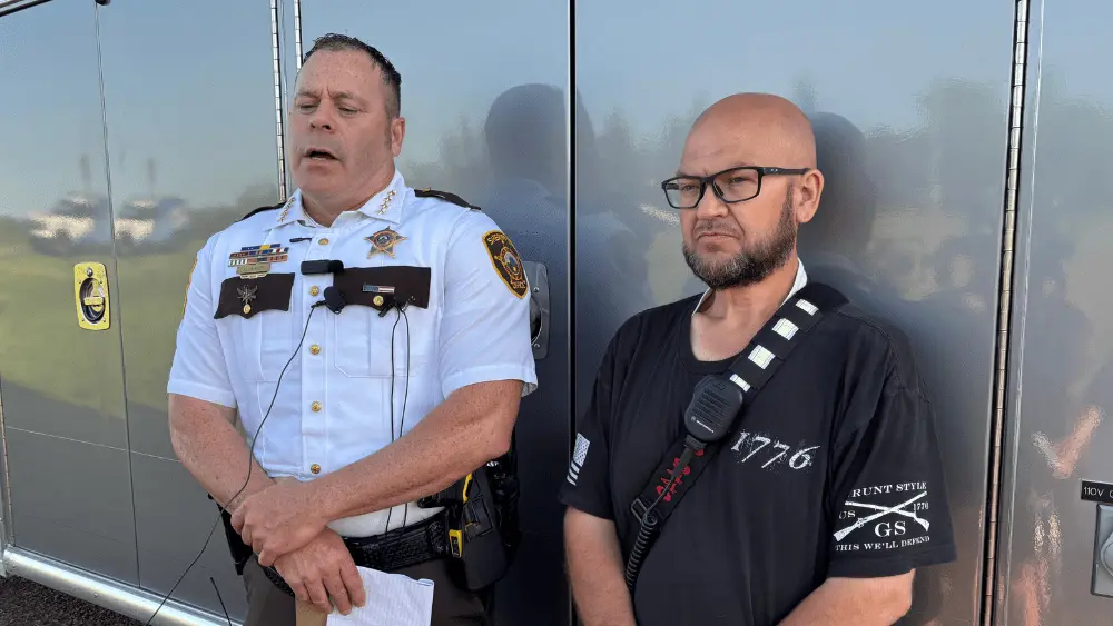 Image of Cass County Sheriff and Enderlin Fire Chief sharing an update on storm damage with the media