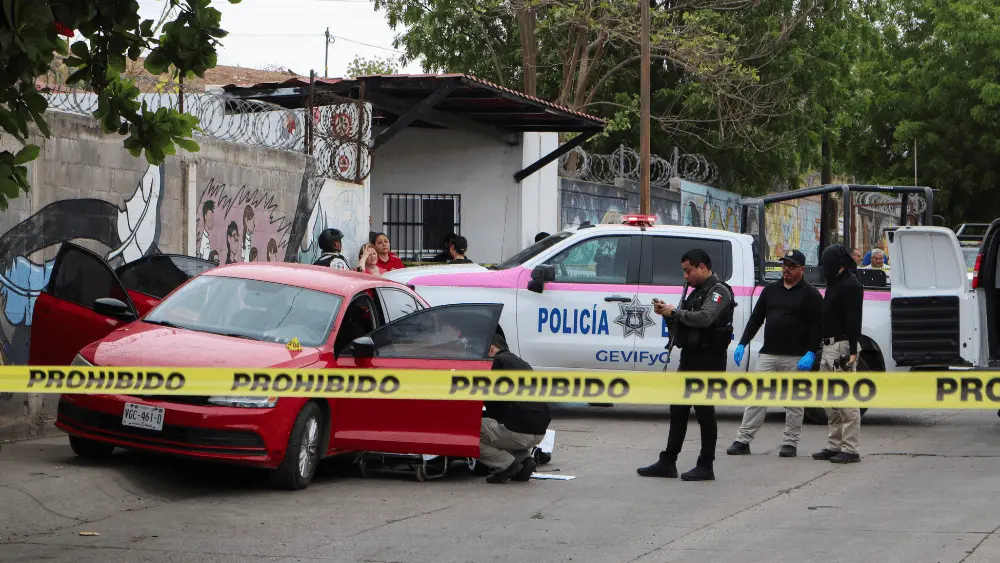 Image of police in Mexico investigating a crime scene related to drug cartel activity