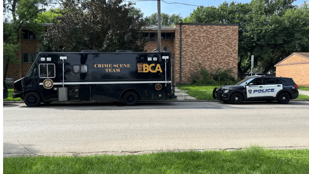 Image of Minnesota BCA Crime Scene Team vehicle and a Moorhead police cruiser at the scene along 2nd Avenue South