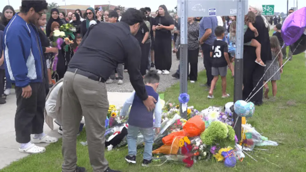 Image of flower ceremony for Adam Amin