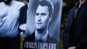 Image of Charlie Kirk poster on easel at vigil