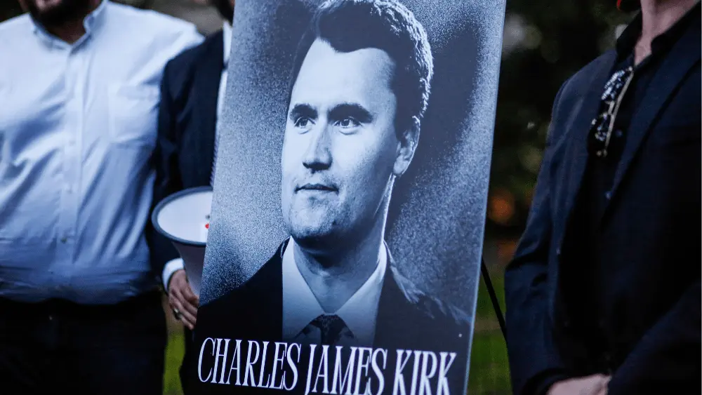 Image of Charlie Kirk poster on easel at vigil