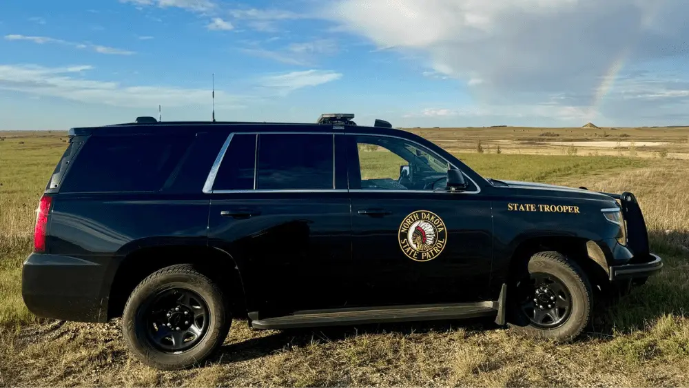 Image of North Dakota State Highway Patrol cruiser parked in a field