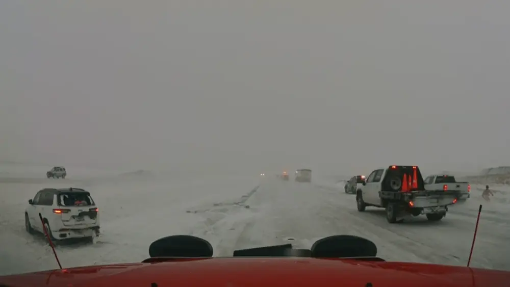 A pickup drives through a scene