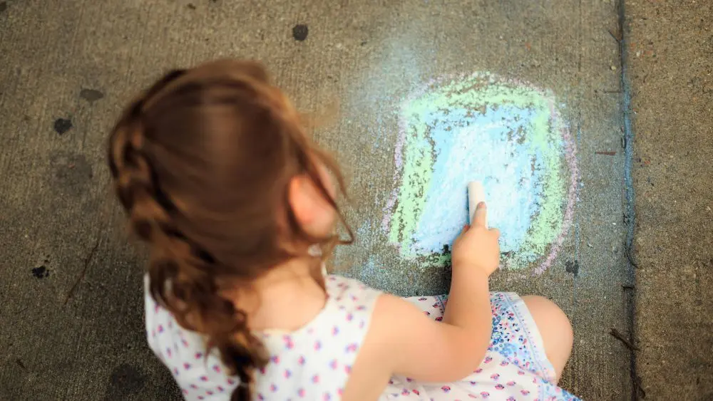 A child drawing with chalk