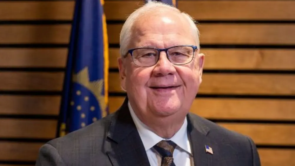 man in front of brown wall
