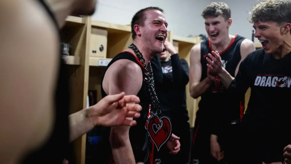 3 basketball players celebrating a win