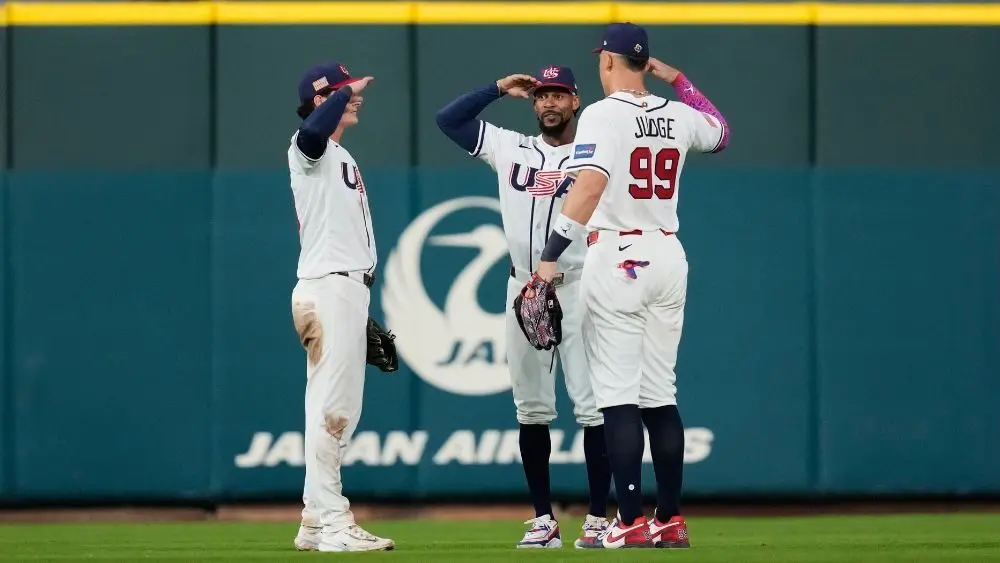 3 baseball players celebrating a win