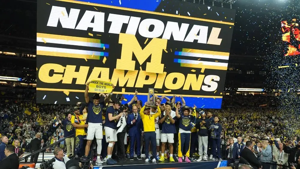 Michigan celebrating their men's basketball national championship win over UConn