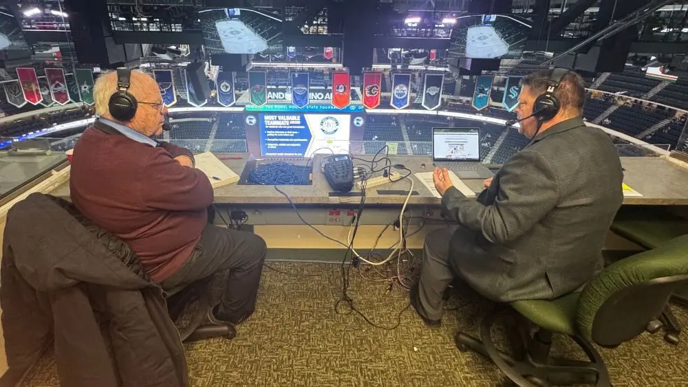 2 guys broadcasting a high school hockey game on radio
