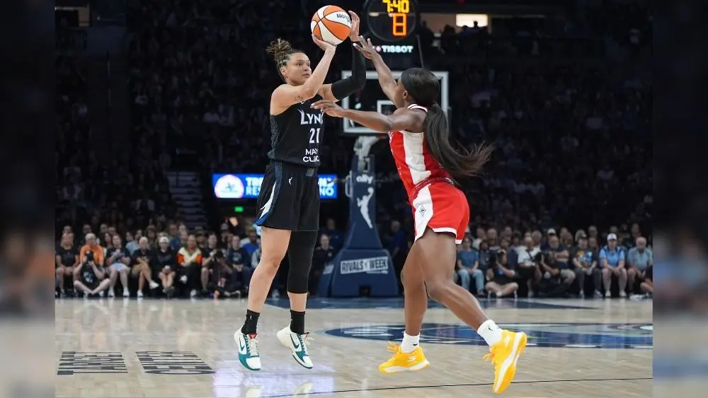 Minnesota Lynx guard Kayla McBride shoots over Las Vegas Aces guard Jackie Young during the first half of a WNBA basketball game