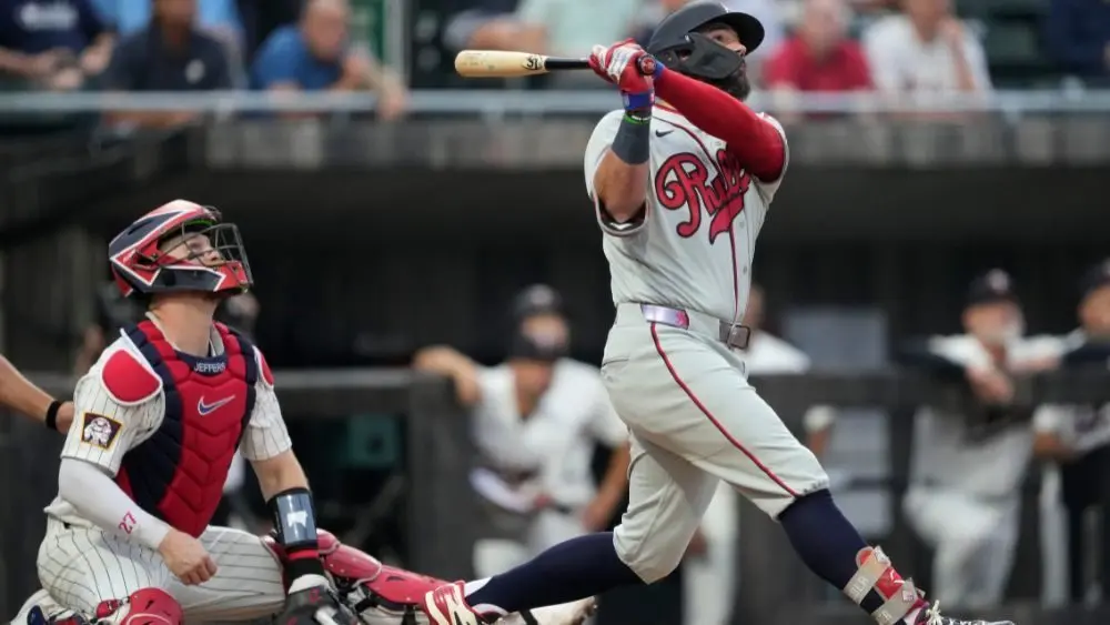 Philadelphia Phillies' Kyle Schwarber hits a home run during the fourth inning of a baseball game against the Minnesota Twins at the Field of Dreams movie site