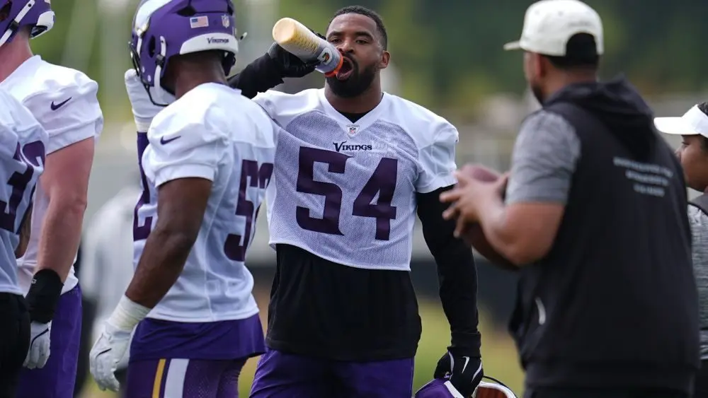 Minnesota Vikings linebacker Jamal Adams hydrates during the team's NFL football training camp